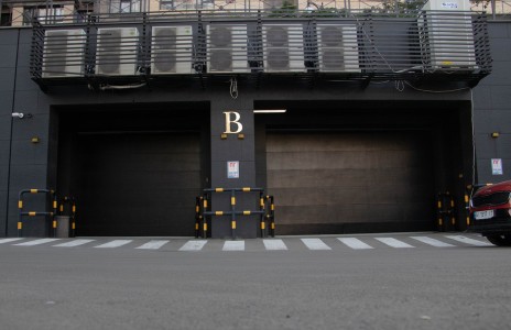 Las máquinas de climatización ubicadas estratégicamente sobre las puertas de los garajes garantizan un control eficiente de la temperatura en todo el edificio. Eficiente climatización en la fachada trasera de la empresa