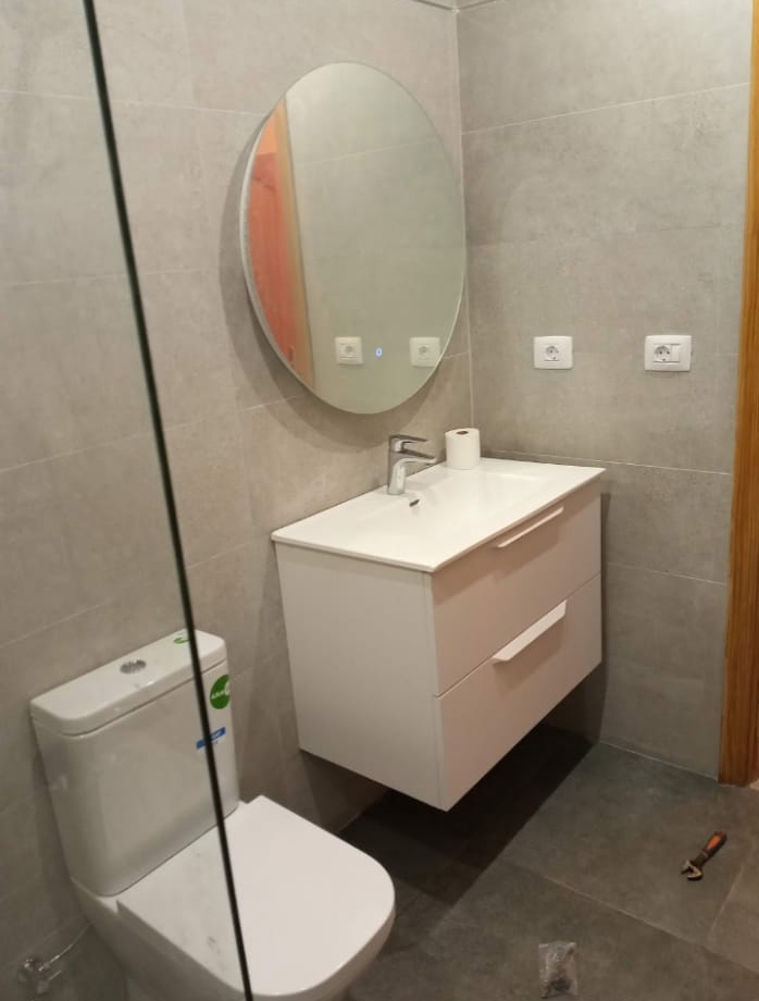 Renovación del cuarto de baño gris 7 Cuarto de baño renovado con estilo moderno y elegante.