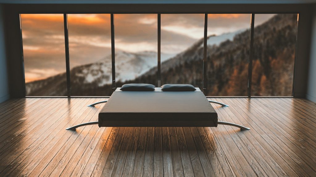 Renovación de suelos de madera 2 Suelo de madera reformado con una cama moderna y ventanales panorámicos